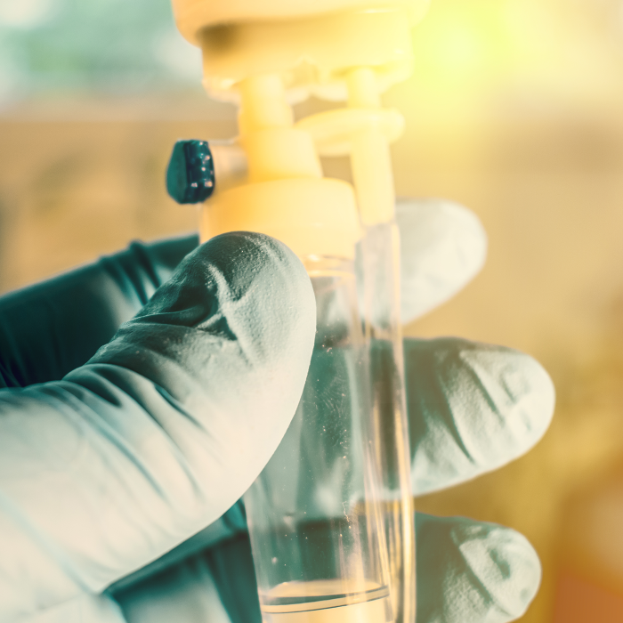 Person holding test tube