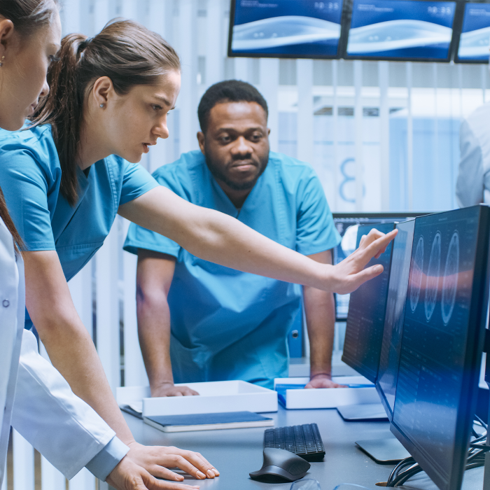 three doctors looking at a scan 