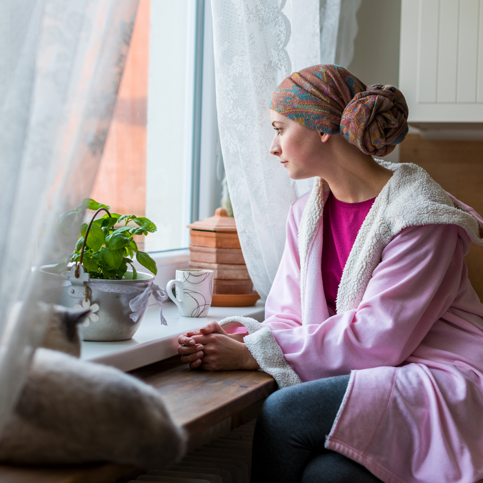 Woman with cancer staring out a window