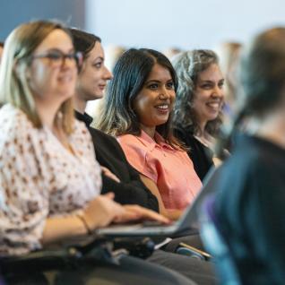 People smiling in auditorium